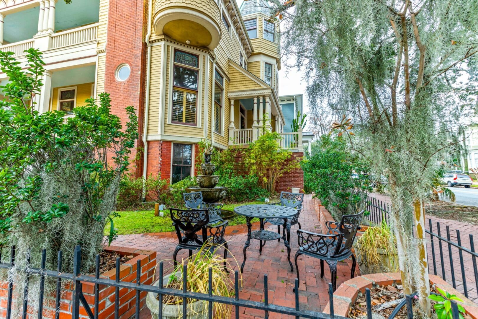 A patio with tables and chairs in front of a house.