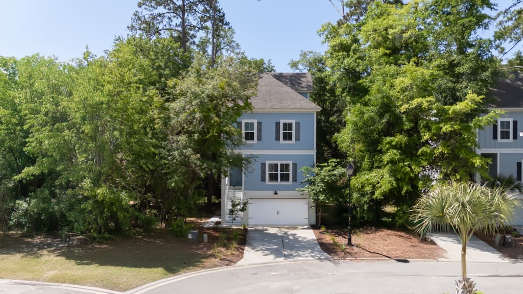 A blue house with trees in the background